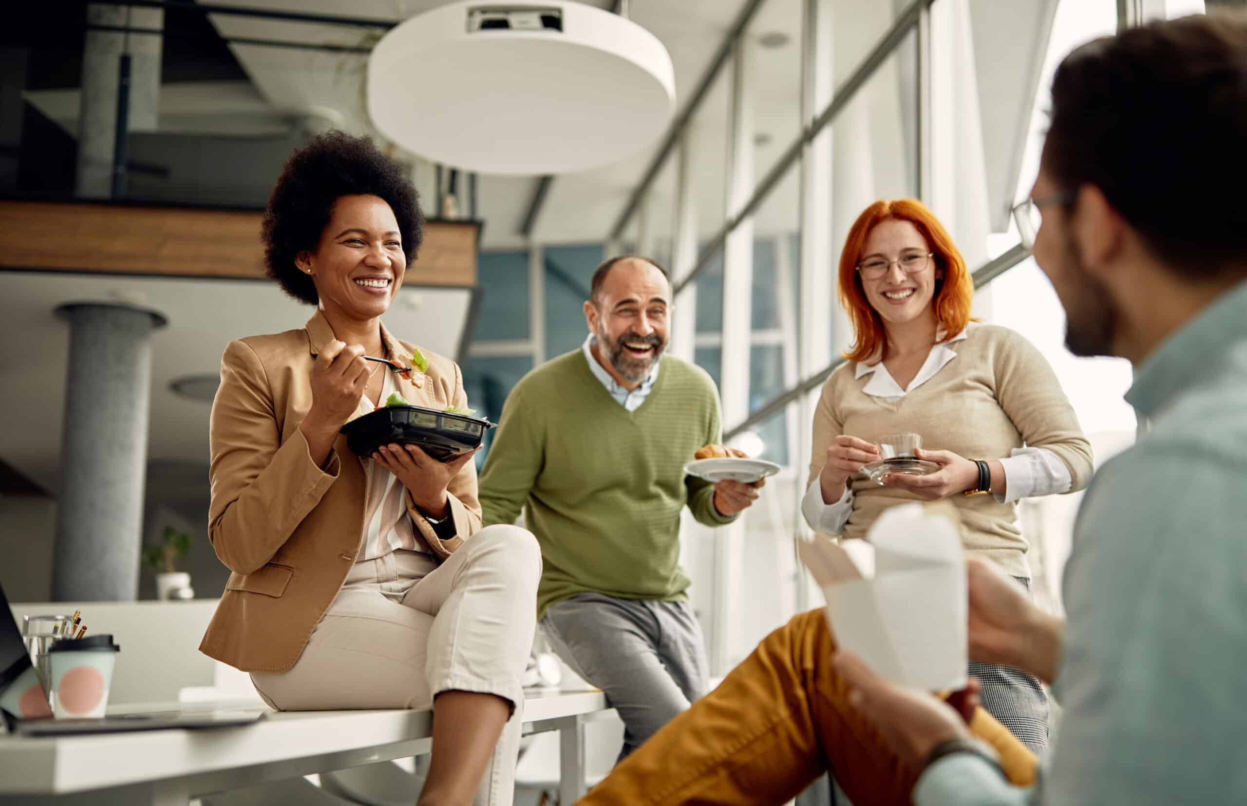 A group of people having lunch at their office in North America